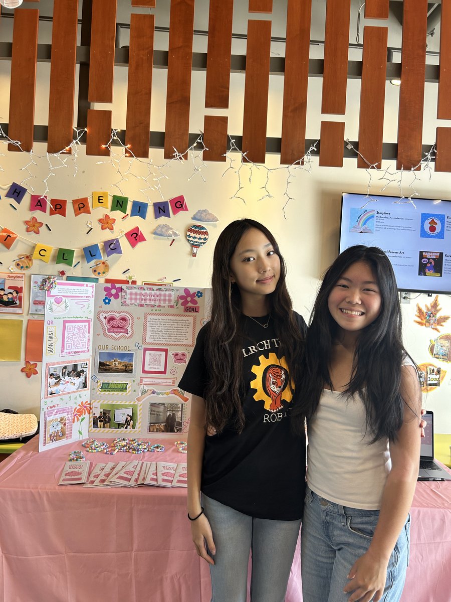 Members at the library booth with the display board