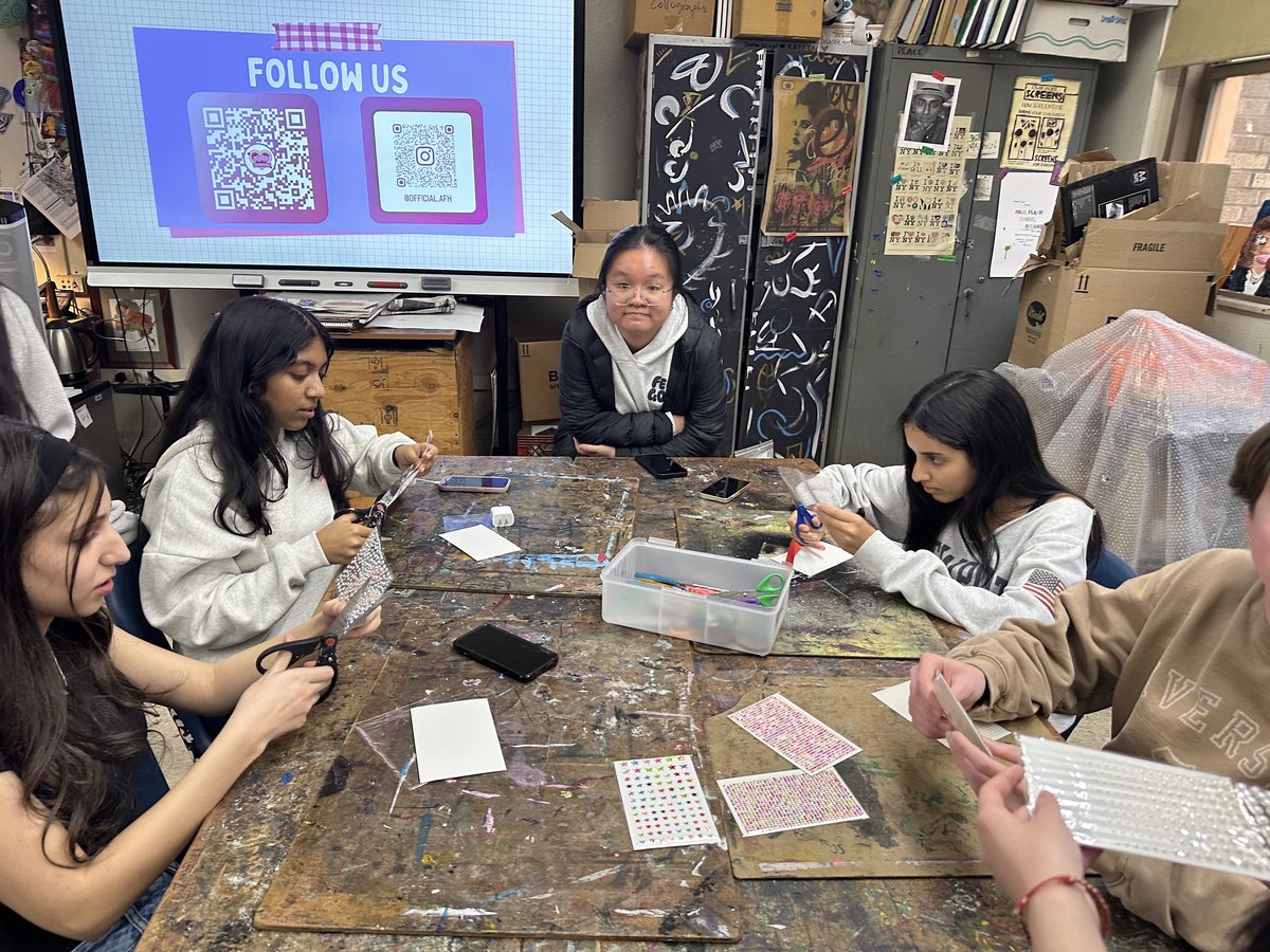 Members assembling sunglasses kits with gem sheets