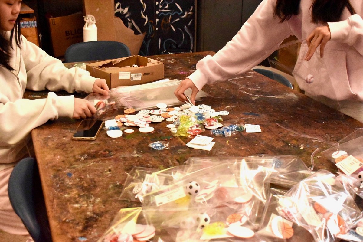Members sorting kit pieces into goody bags