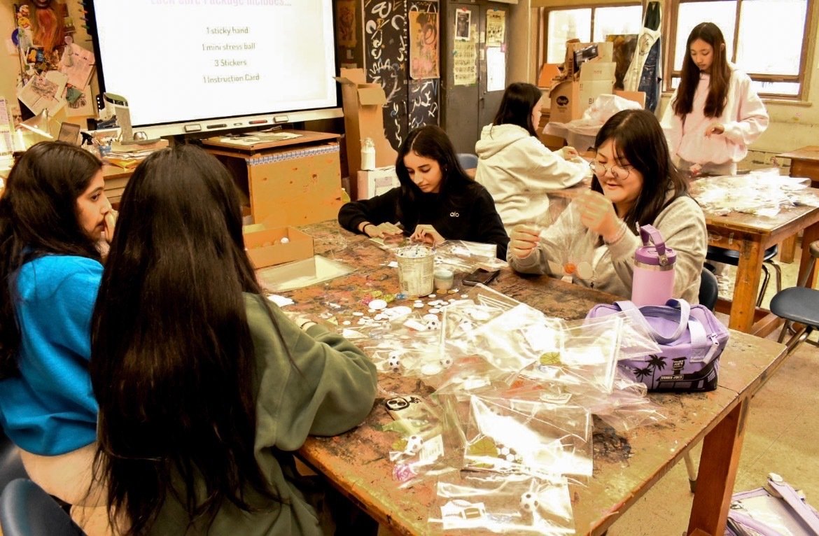 Members working together on the goody bag assembly