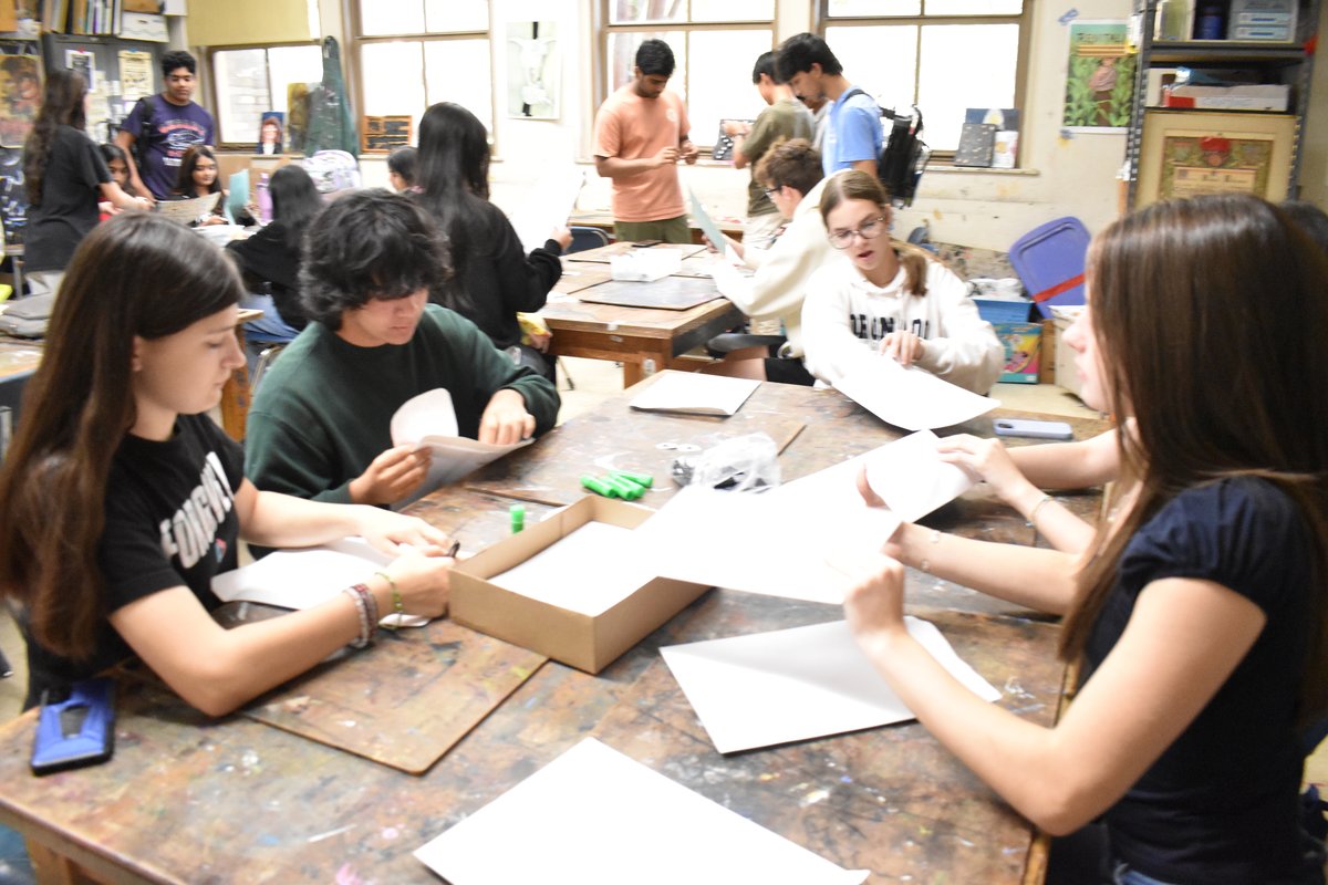 Members assembling jellyfish kits with paper strips