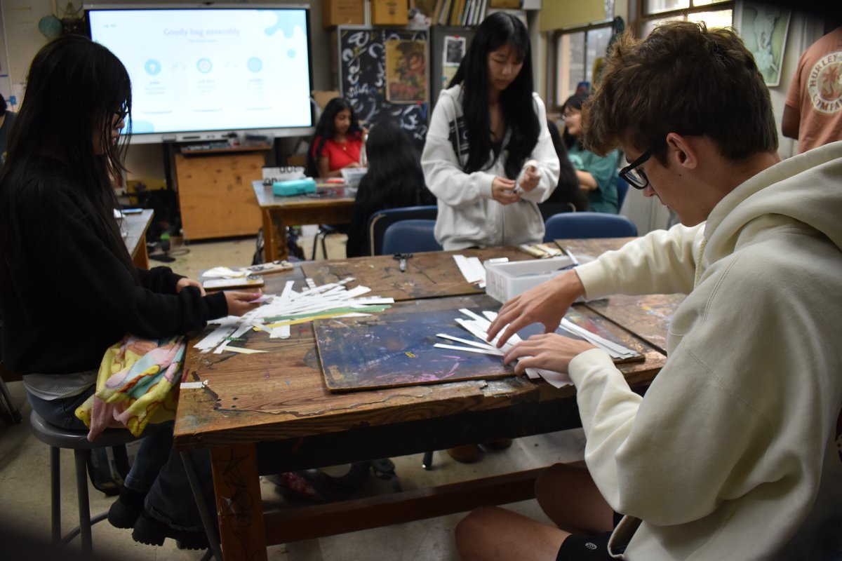 Members cutting and rolling strips for the jellyfish kits