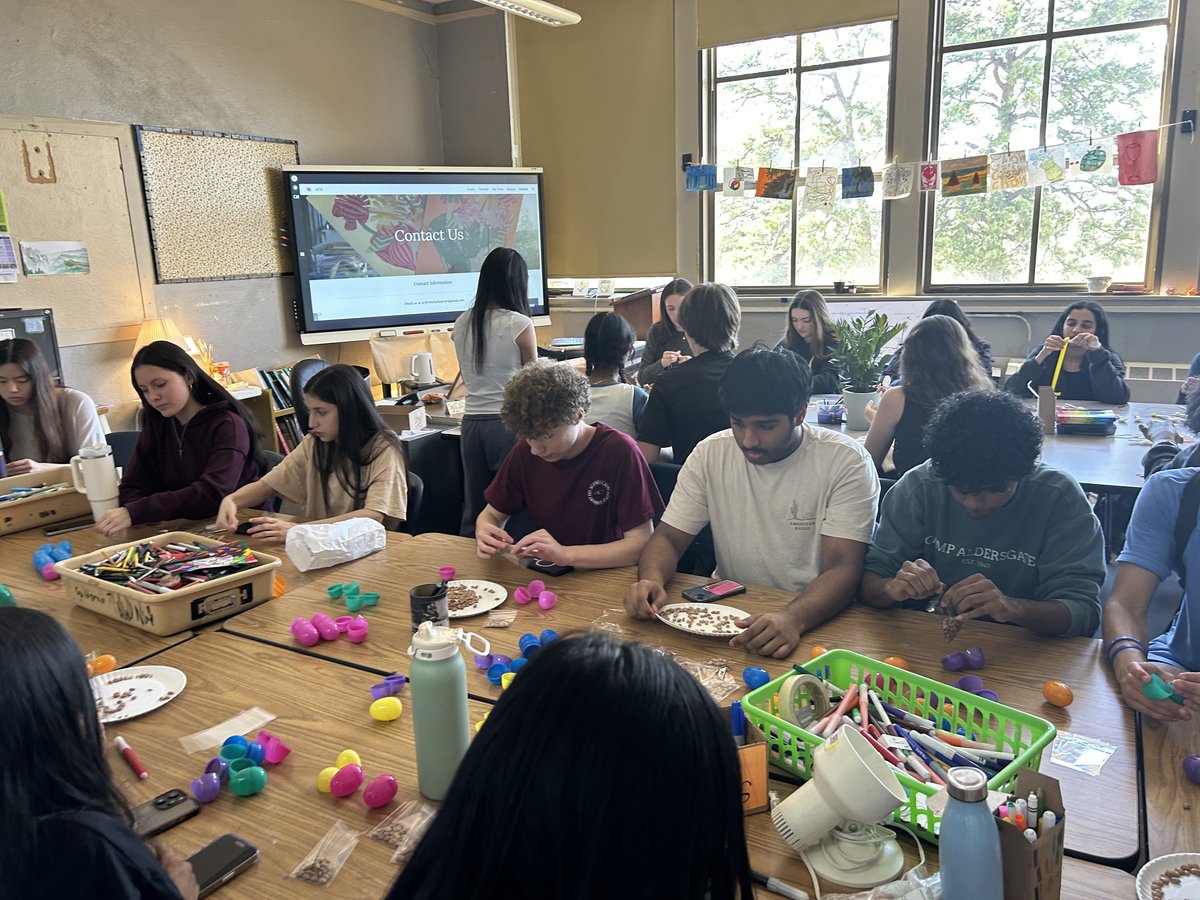 Members working on maraca kits during the assembly meeting