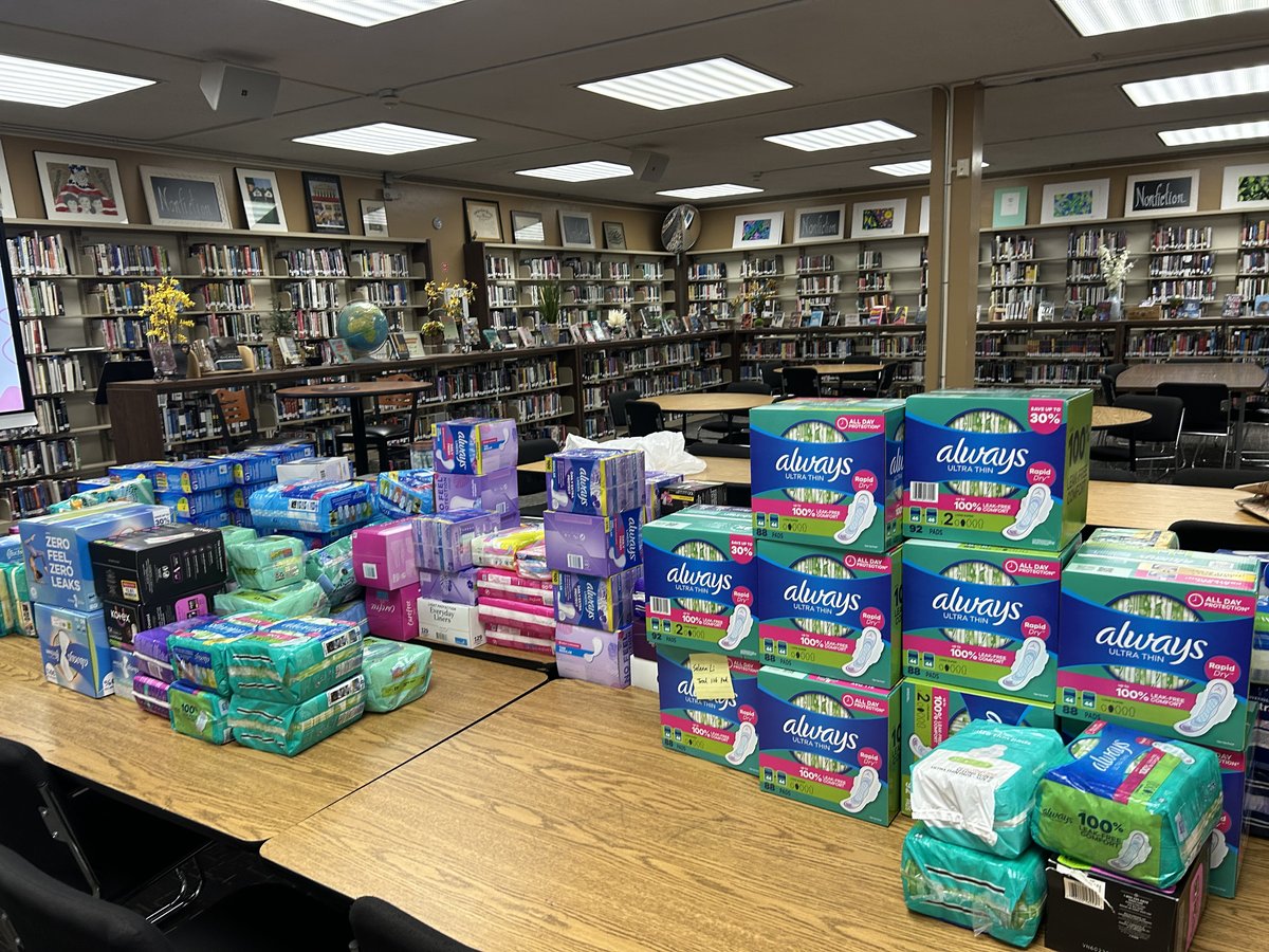 Tables stacked with donated period products at the LRCH Library