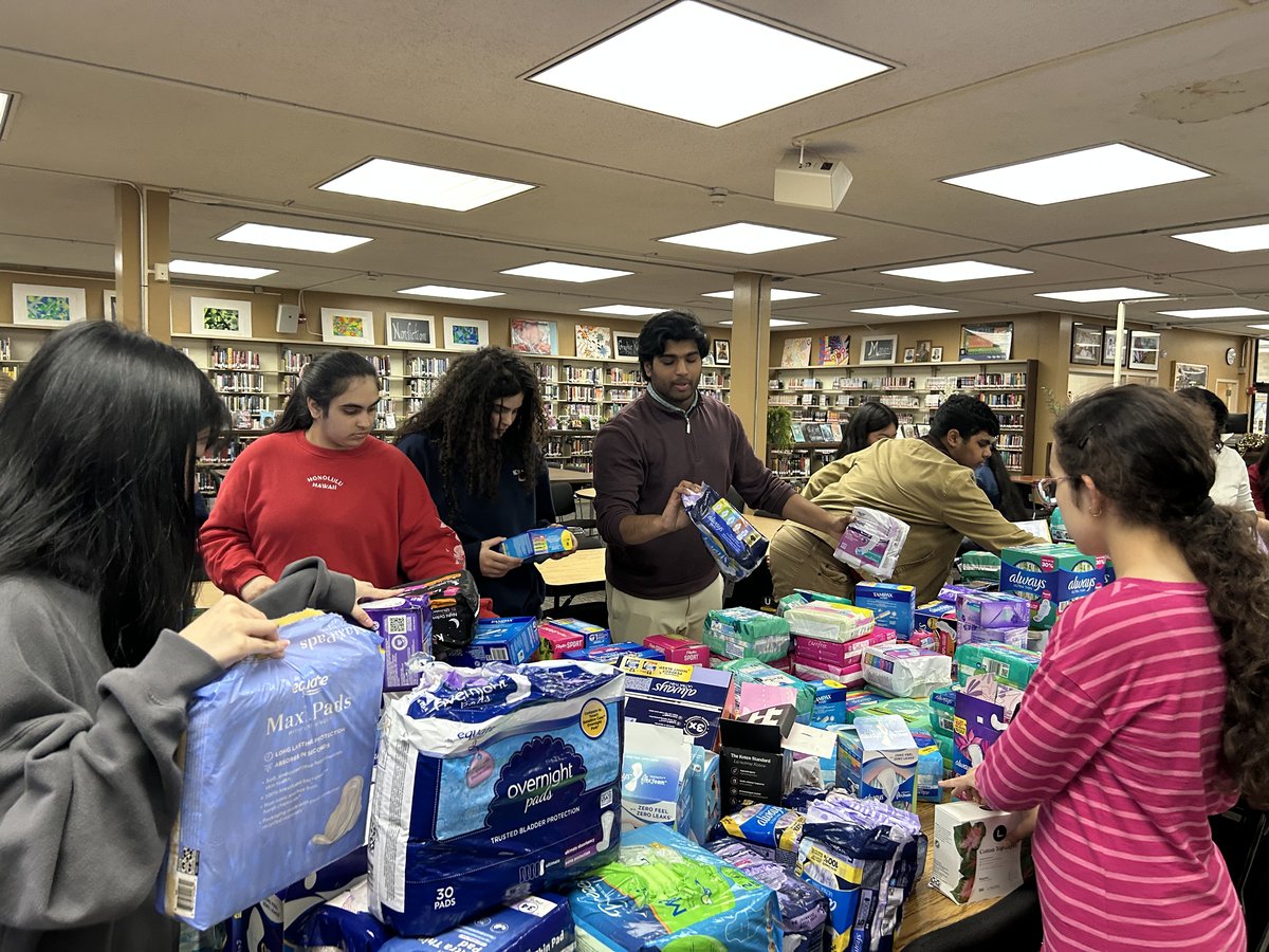 Members sorting period products into care packages