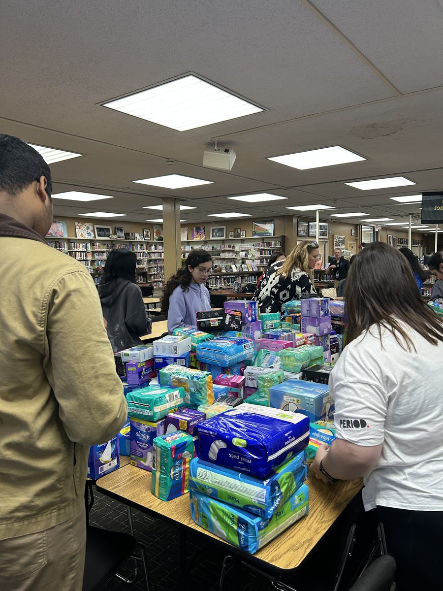 Members organizing period product supplies at the tables