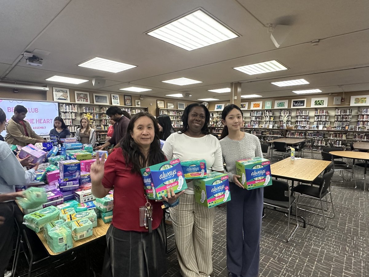 Members posing with the period product donations